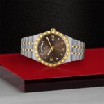 Luxurious silver and gold watch with a deep brown sunburst dial and elegant design.