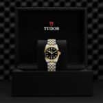 Tudor watch in luxurious presentation box, showcasing elegance with gold and silver detailing.