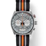 Seiko chronograph watch with stainless steel case and sporty fabric strap in gray and orange.