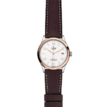 Tudor watch with elegant design, rose gold bezel, white dial, and leather strap.
