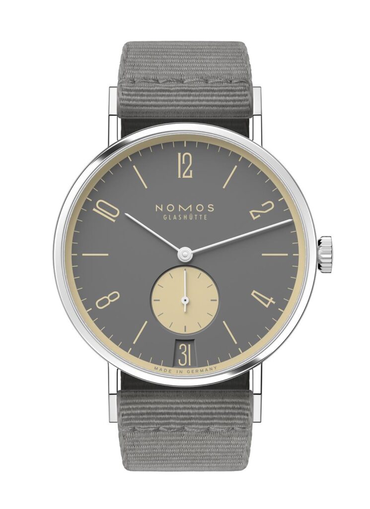 NOMOS Glashütte luxury watch features an oval design with a gray dial, yellow accents, and date function.