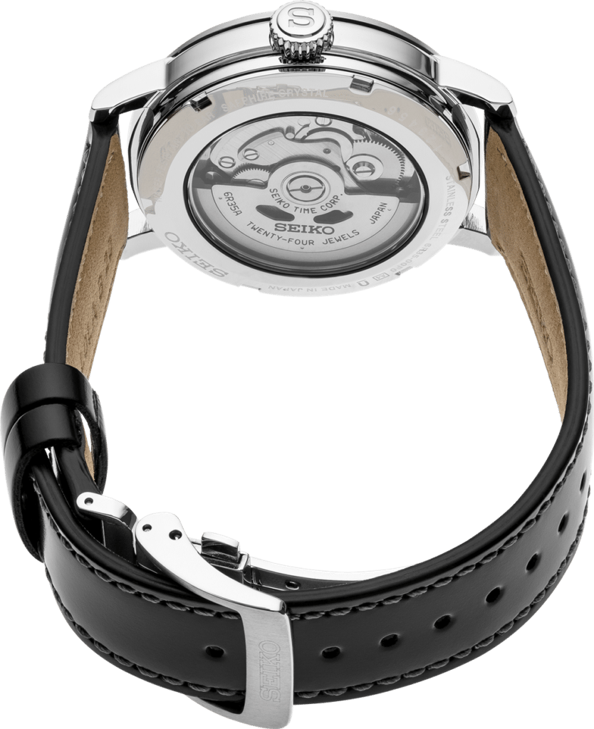 Seiko watch with transparent case back, polished stainless steel, and luxurious black leather strap.