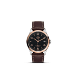 Sophisticated Tudor watch with black dial, rose gold bezel, and brown leather strap.