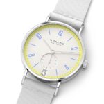 Minimalist NOMOS Glashütte watch with pale yellow dial and blue accents for modern elegance.