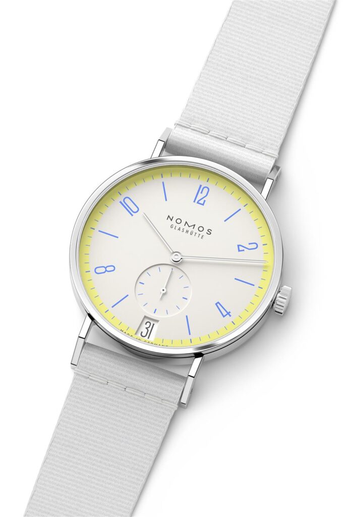 Minimalist NOMOS Glashütte watch with pale yellow dial and blue accents for modern elegance.