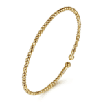 Elegant gold bangle bracelet with textured beads, perfect for casual and formal occasions.