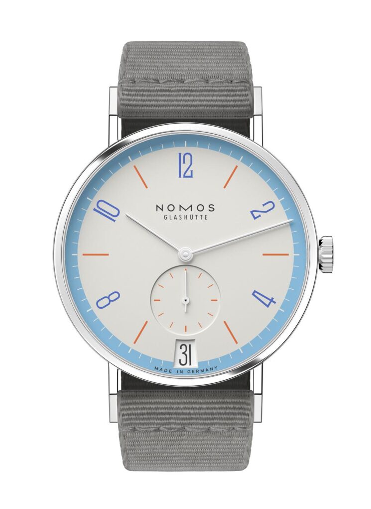 Elegant NOMOS Glashütte watch with minimalist design, pale cream face, and gray fabric strap.