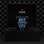 Tudor luxury watch in elegant presentation box with deep blue dial and navy strap.