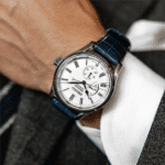 Elegant Seiko wristwatch with a white dial and blue leather strap on a hand.
