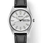 Elegant Seiko watch with silver case, minimalist dial, and black leather strap for versatile style.