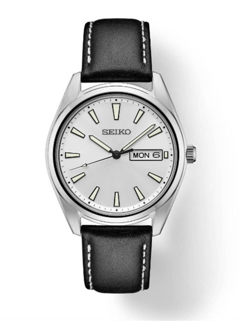 Elegant Seiko watch with silver case, minimalist dial, and black leather strap for versatile style.