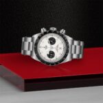 Elegant chronograph watch on red and black background, showcasing luxury and modern design.