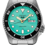 Vibrant Seiko automatic watch with turquoise dial and black rotating bezel, perfect for any occasion.