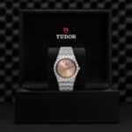 Luxurious Tudor watch in elegant box showcasing exquisite craftsmanship and striking rose gold dial.