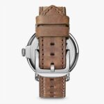 Stylish wristwatch with a brown leather strap and polished metal case, perfect for any occasion.