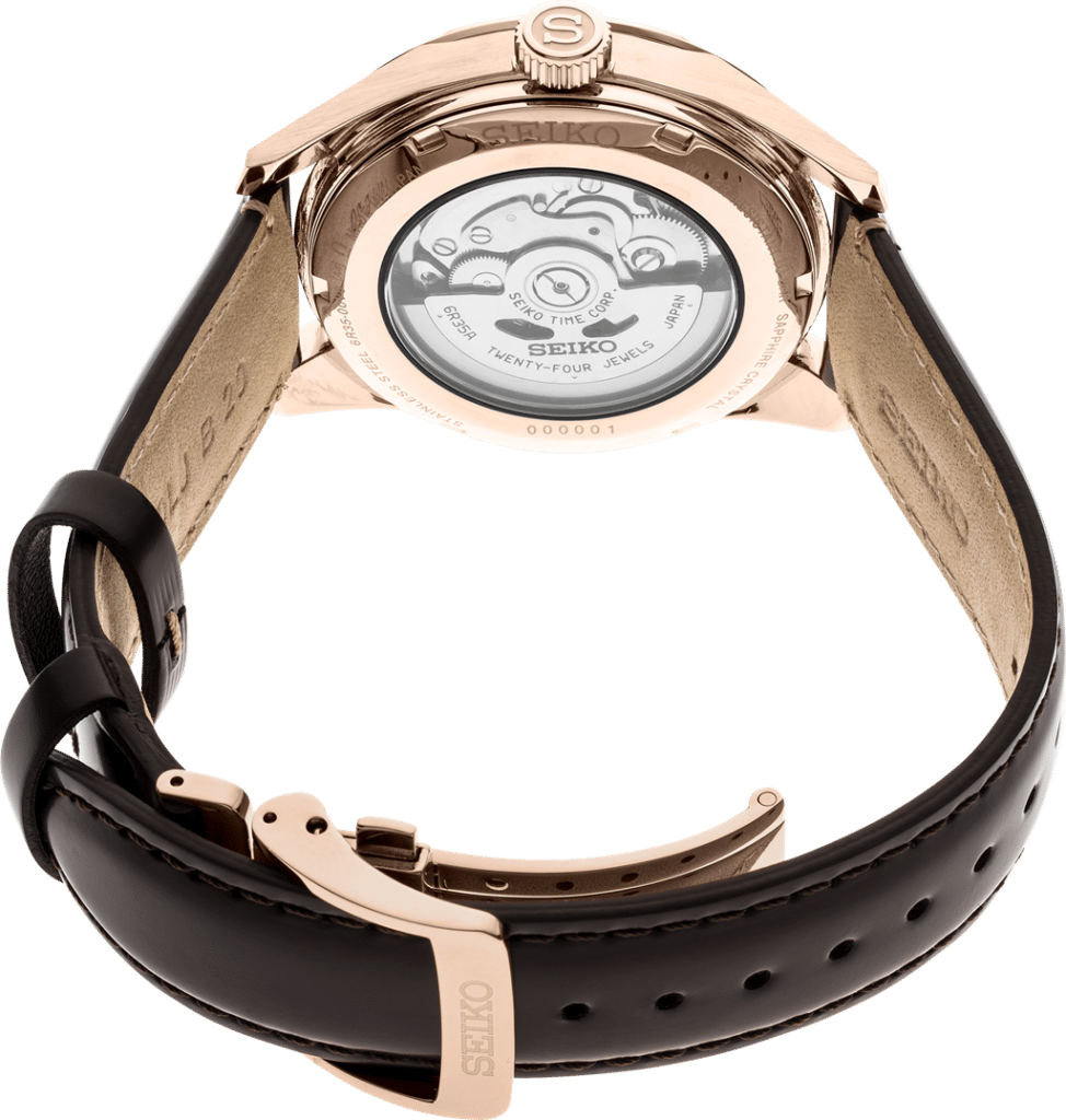 Seiko rose gold watch with transparent back showcasing intricate mechanical movement and luxury design.