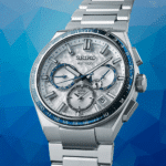 Sleek Seiko Astron watch with advanced GPS and solar features on a stylish blue background.