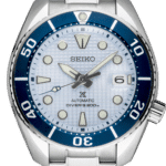Seiko divers watch with stainless steel case, blue dial, and luminous hands for underwater adventures.