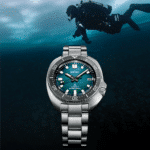 Seiko dive watch in turquoise, showcasing style and functionality against an underwater adventure backdrop.