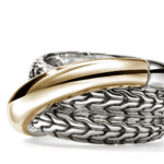 Elegant silver and gold interlaced bracelet showcasing modern jewelry design and artisanal craftsmanship.