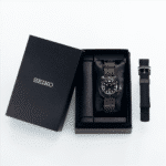 Elegant Seiko watch in a luxurious black box with a brown woven strap and silicone accessory.