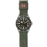 Tudor Pelagos GMT watch with black dial, stainless steel case, and rugged green fabric strap.