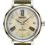 Elegant Seiko octagonal watch with iridescent mother-of-pearl face and sage-green leather strap.