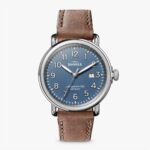 Stylish Shinola watch with blue dial and tan leather strap, perfect for any occasion.