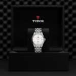 Luxurious Tudor watch in elegant black box, showcasing sophisticated design and craftsmanship.