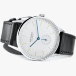 Elegant NOMOS Glashütte wristwatch with a white dial, blue hands, and black leather strap.
