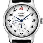 Elegant Seiko Presage automatic watch with silver case, black leather strap, and vibrant red accents.