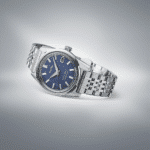 Elegant Seiko watch with blue dial and stainless steel bracelet on a stylish gradient background.