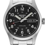 Silver-toned Seiko automatic watch with black dial, Arabic numerals, day-date display, and stainless steel bracelet.