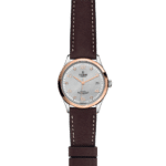 Tudor watch with rose gold bezel, textured silver dial, and leather strap showcasing elegance.