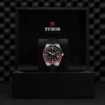 Elegant Tudor watch in luxurious case, showcasing sporty design and high-quality craftsmanship.