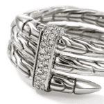 Elegant silver ring with intertwined strands and shimmering gemstones for modern jewelry lovers.