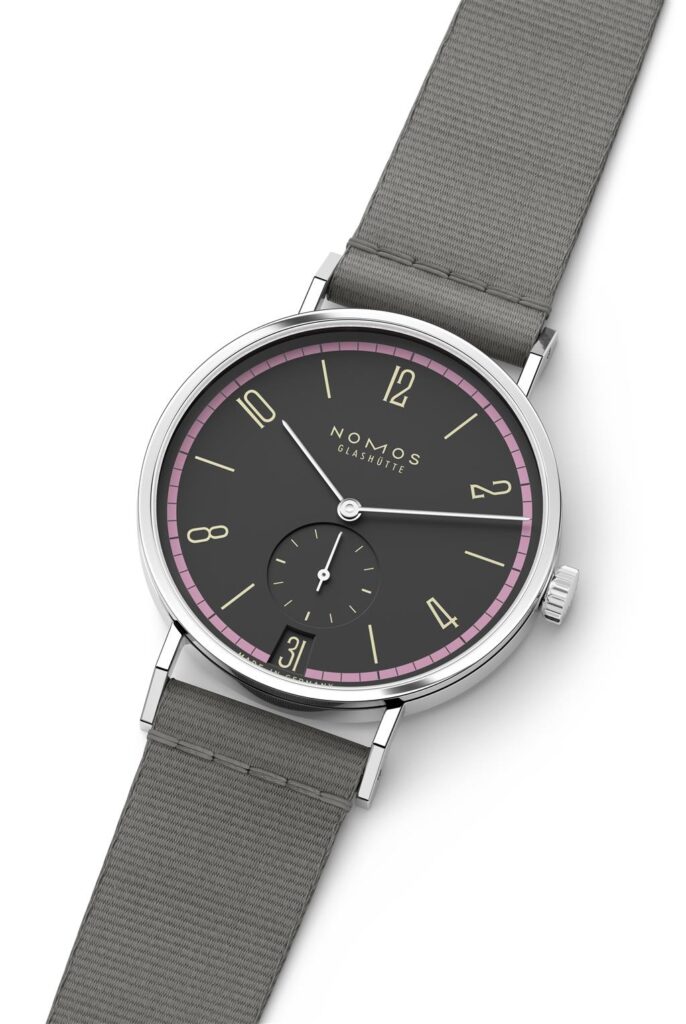 Sleek NOMOS Glashütte watch featuring a gray dial, pink bezel, and textile strap.