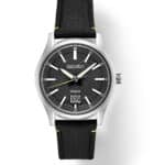 Modern black dial watch with textured design, metallic accents, and durable fabric strap.