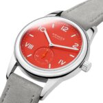 Vibrant red NOMOS watch with stainless steel case and suede strap blends modern design and craftsmanship.