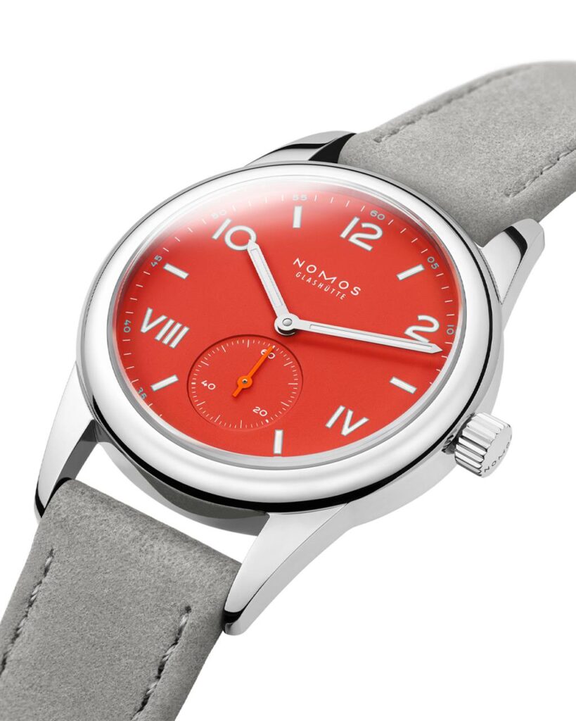 Vibrant red NOMOS watch with stainless steel case and suede strap blends modern design and craftsmanship.
