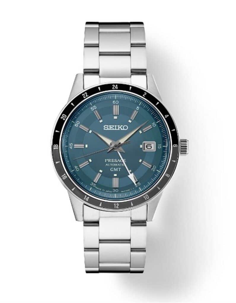 Elegant Seiko Presage GMT watch with teal dial, stainless steel case, and date function.