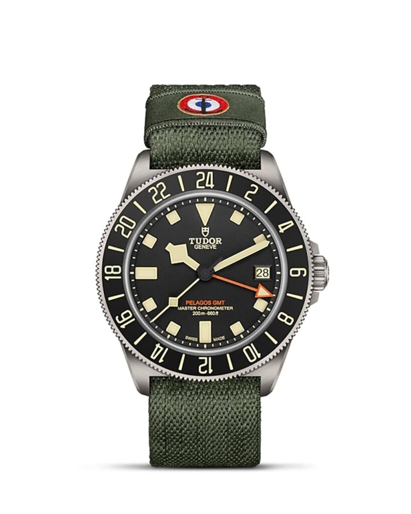 Tudor Pelagos GMT dive watch with titanium case, black dial, and green fabric strap.