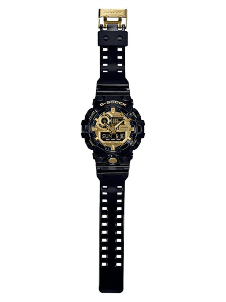 G-SHOCK rugged watch with gold accents, multifunctional digital display, and stylish black resin strap.