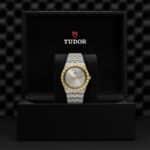 Luxurious Tudor watch in a stylish black box showcasing dual-tone silver and gold design.