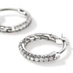 Elegant silver hoop earrings with shimmering gemstones for a sophisticated jewelry look.