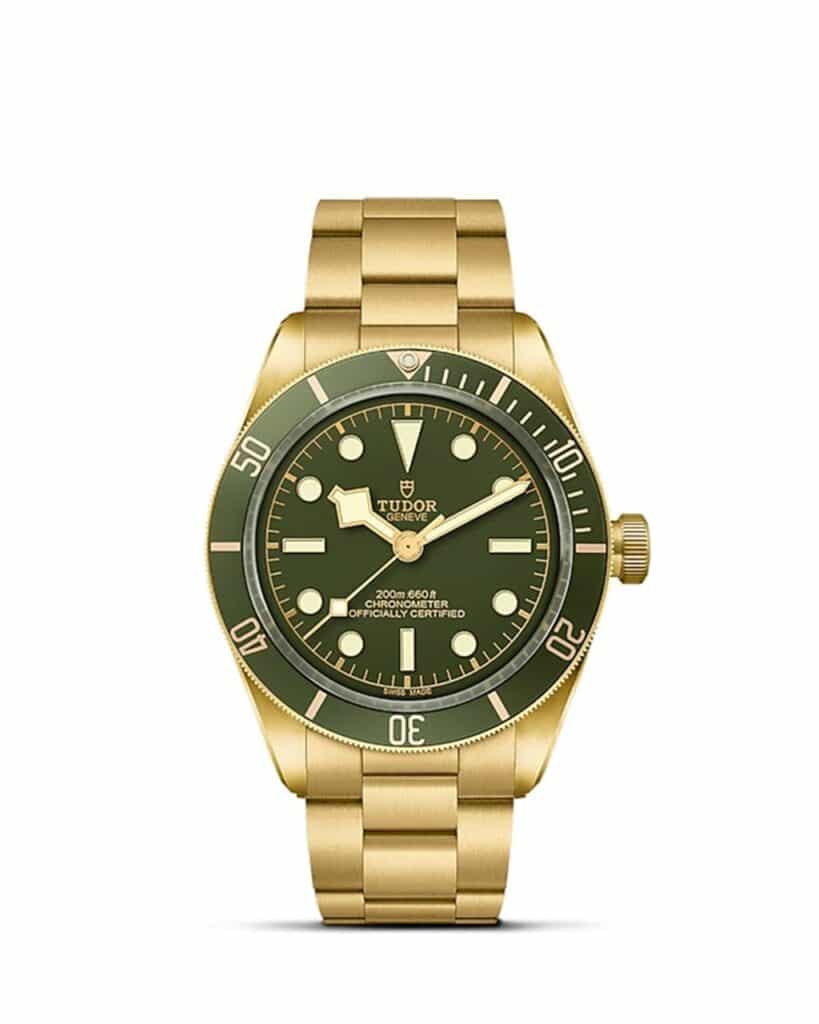 Luxurious Tudor watch featuring a vibrant green dial and elegant gold-tone case and bracelet.
