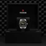 Tudor stainless steel watch in a luxurious black presentation box, showcasing elegance and craftsmanship.