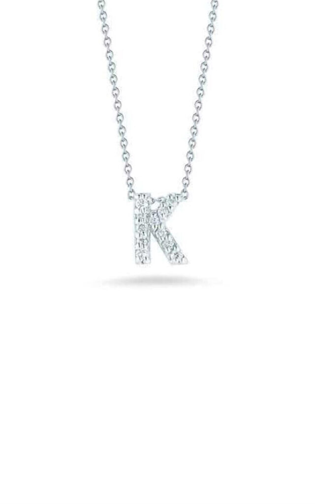 Sparkling necklace with a letter K pendant, adorned with shimmering stones on a silver chain.