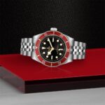 Stunning Tudor watch with black dial and red bezel, showcasing exquisite craftsmanship and timeless elegance.