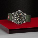 Tudor diving watch with black dial and green strap, perfect for adventure enthusiasts.